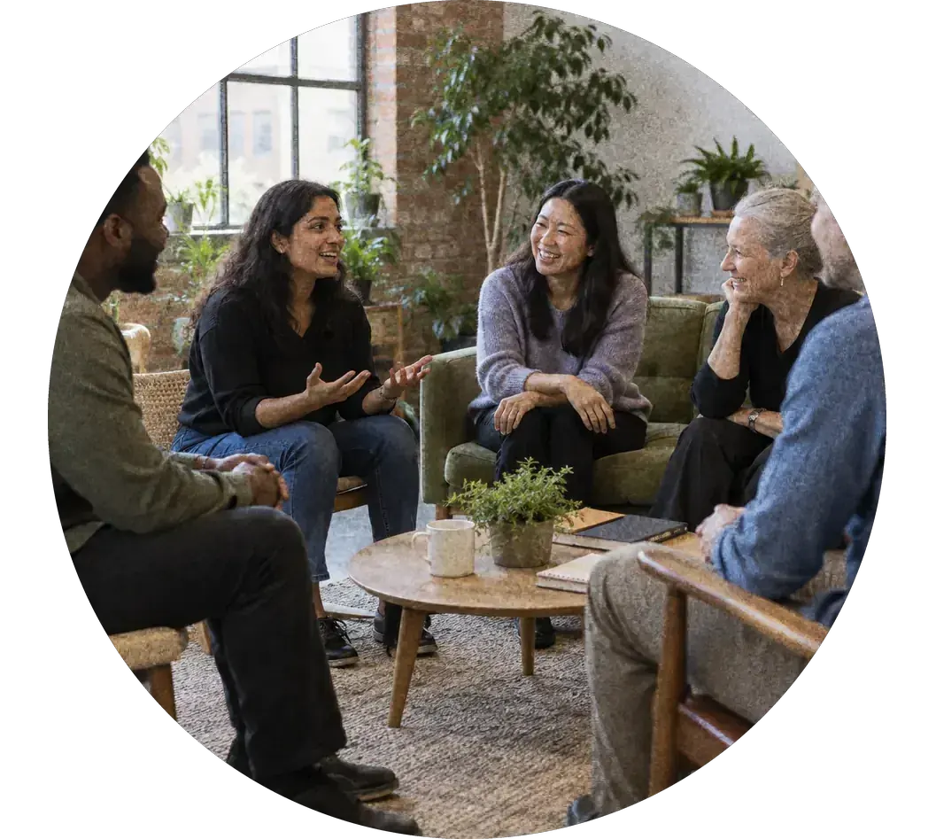 A small team talking in a relaxed group session in a bright office